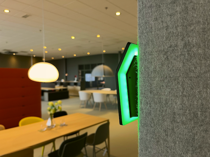 Humly Booking Device mounted on a wall in an office lounge